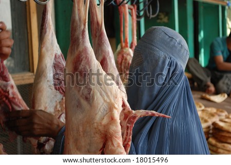 Afghan woman buys meat