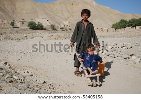 عكسهاي افغانستان Stock-photo-keshim-afghanistan-august-afghan-boy-from-keshim-badakhshan-pushes-his-little-sister-53405158
