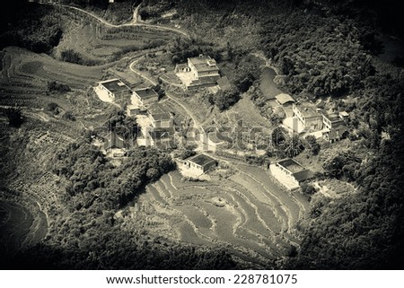 Beautiful View of Traditional Southern Chinese Countryside, There are Brick Houses and a Terrace Field With Some Trees Around in Vintage Style