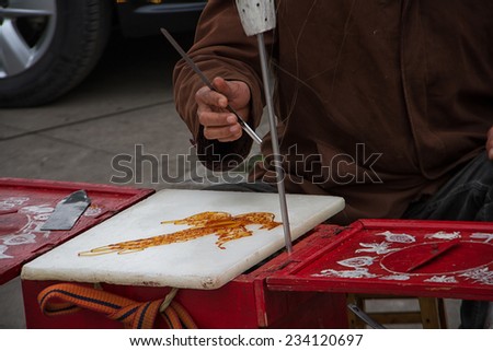 Chongqing, China - February 14, 2014: Close up of a phoenix-like sugar painting, a kind of traditional Chinese street snack