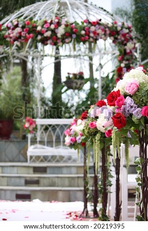 stock photo Floral Arrangement on Wedding Aisle with Gazebo in Background