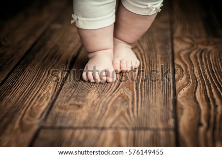 baby feet doing the first steps Baby\'s first steps.