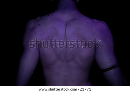 young male back showing muscles in purple light