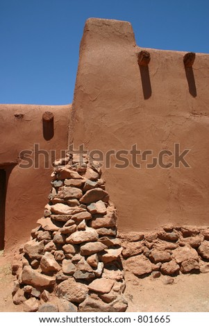 Detail of rock buttress at corner of centuries old hacienda located in the desert near Santa Fe, New Mexico.