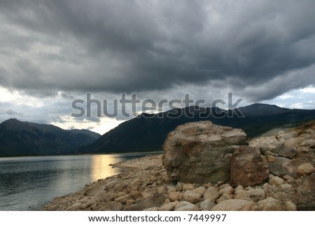 Ominous storm clouds gather over Twin Lakes fishing beach in the Southern Colorado Rocky Mountains