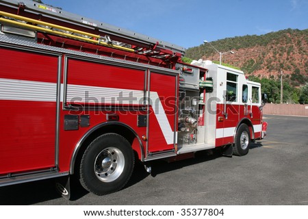Bright red fire engine used to respond to emergency in mountain town.