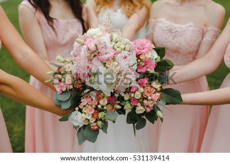 bridesmaids holding bouquets at the center