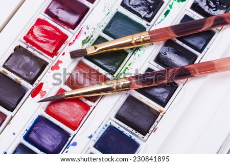 Artists watercolour paints  with brushes and pencil background hobbies and leisure time