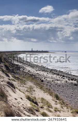 View along Spurn Point coastline with lighthouse, nature reserve, east yorkshire, UK