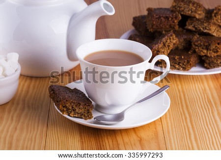 Cup of English Tea with Cake for Tea Break in Afternoon with silver spoon and bowl of sugar cubes