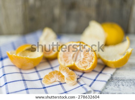 Sweet mandarin oranges opened in half on tea towel background