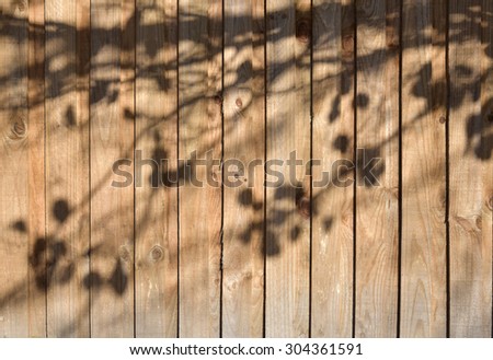 Wooden fence texture background with tree shadow