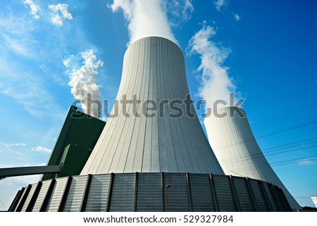 Coal Power Plant smoking and steaming against blue sky