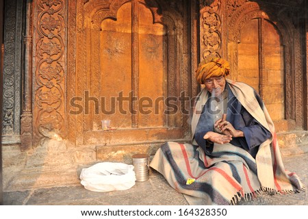 KATHMANDU, NEPAL - MAR 24:Unidentified old Nepalese man smokes cigarette in Kathmandu on March 24, 2013. As of 2011 Nepal census report, life expectancy at birth is estimated at 64.94 years for males.