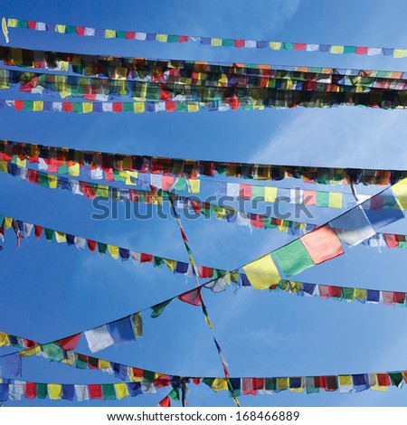 colorful bunting flags against a blue saturated sky