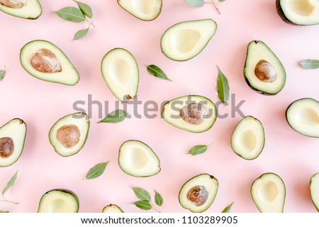 Avocado on pink background. Tropical abstract background with avocado. Food concept. flat lay, top view