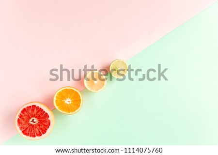 Creative pattern made of summer tropical fruits: grapefruit, orange, lemon, lime on colorful background. Food concept. flat lay, top view