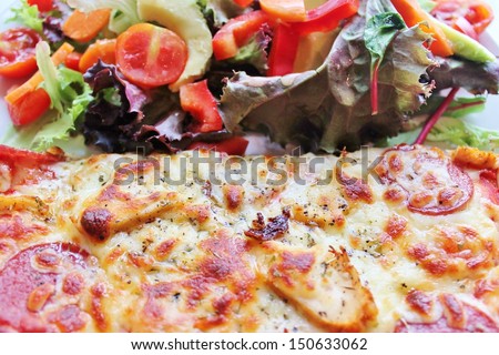 Pizza and healthy fresh nutritious salad