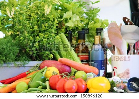 Kitchen preparation for chef vegetables, herbs, and utensils