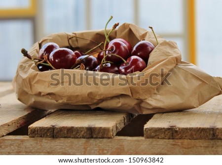 Brown paper bag of juicy ripe fresh nutritious cherries for Australia Christmas