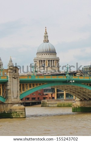 View of St. Pauls Cathedral across Thames in London and London Bridge