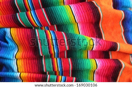 mexican traditional handwoven rug poncho fiesta with stripes and bright colors