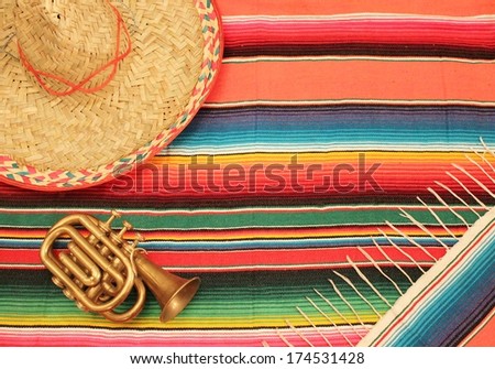 Traditional Mexican fiesta poncho rug  in bright colors with sombrero background with copy space