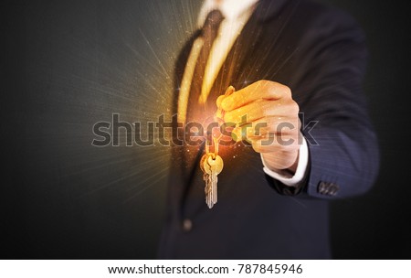 Formal man hand over shiny keys with dark background