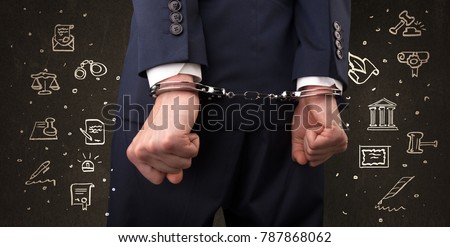 Chalk drawn courthouse symbols and close handcuffed hands in suit