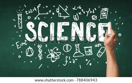 A teacher writing science, drawing chemistry elements on clean green chalkboard by hand