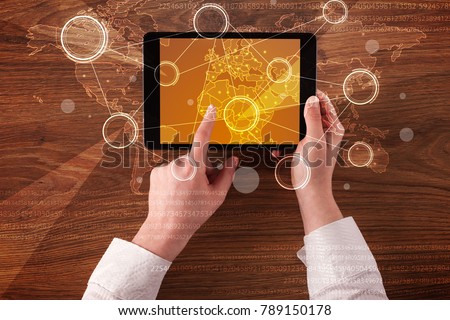 Caucasian business hands holding tablet with orange business-statistics screen