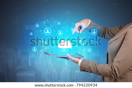 Hand holding tablet and showing staffs with global connectivity concept