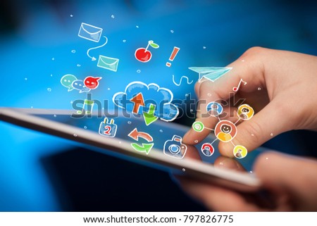 Female hands touching tablet with colorful social media icons