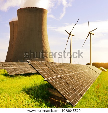 Solar panels, nuclear power plant and wind turbines at sunrise. Energy resources concept.