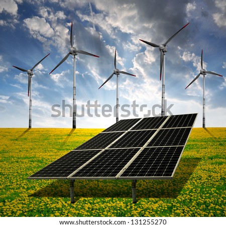solar energy panels and wind turbine in sunset