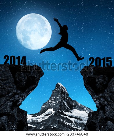 Girl jumps to the New Year 2015 in the background mount Matterhorn. \