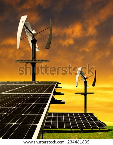 Solar energy panels with wind turbines in the setting sun
