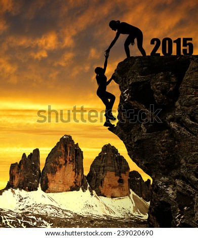 Silhouette girls climbs into the New Year 2015. In the background Tre Cime di Lavaredo.