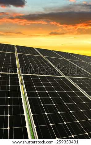 Solar energy panels against sunset sky
