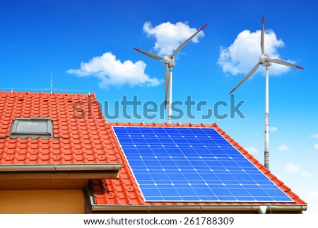 Solar panel on the roof of the house in the background wind turbines.