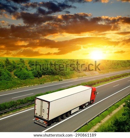 Truck on the highway at sunset.