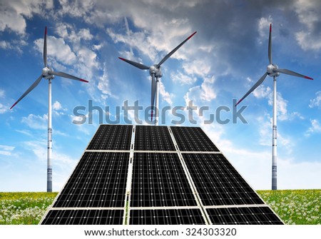 Solar panels with wind turbines in the setting sun. Concept of clean energy.