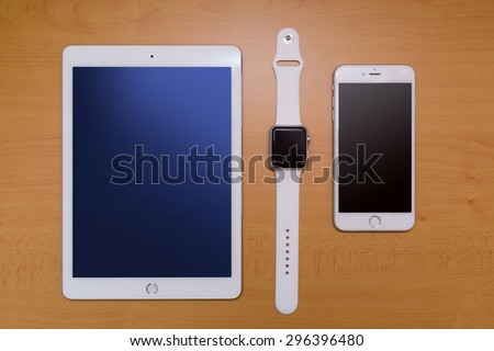White Smart-phone And Digital tablet And White Smart-watch.  on wood desk.