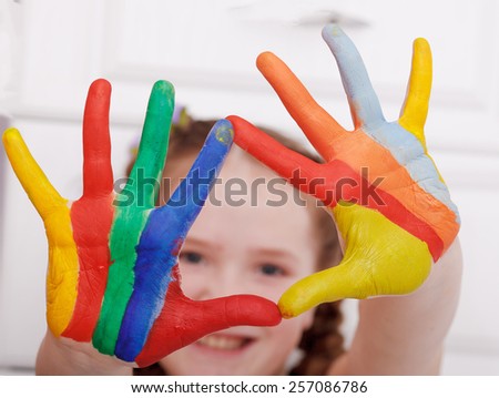 Girl hands painted in bright colors, ready for hand prints