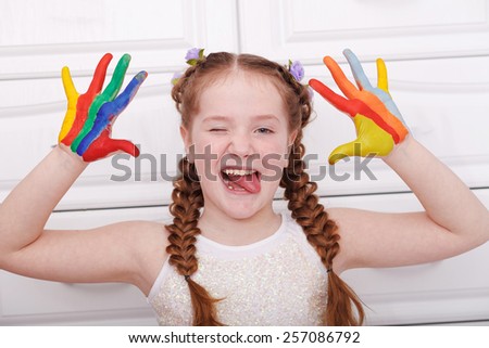 Girl hands painted in bright colors, ready for hand prints