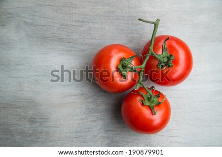 fresh red delicious cherry tomatoes on an  old wooden tabletop, selective focus