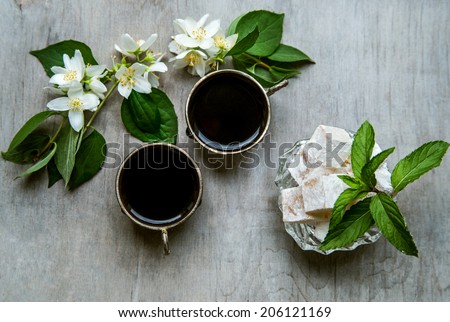 Coffee in arabian silver vintage cups on wooden background, jasmine, Arabic style, close-up, selective focus