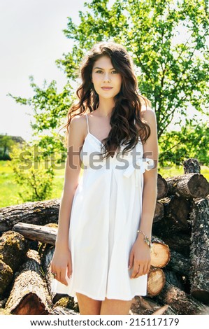 portrait of beautiful model in white dress. rural landscape, outdoor. spring, summer or autumn season