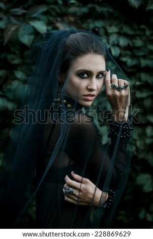 Fashion model dressed in gothic dark style. Vamp style. Dark bride.