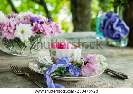 Tableware decoration outdoor with flowers and color glasses